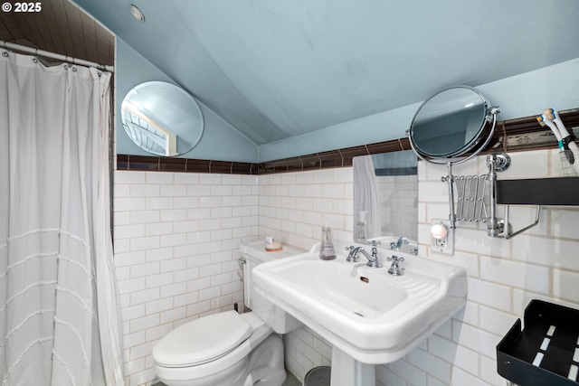 3113 SE Main St, Portland, OR 97214 - bathroom featuring vaulted ceiling, tile walls, toilet, a shower with shower curtain, and a sink