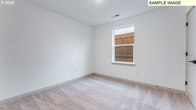 unfurnished room featuring carpet floors, visible vents, and baseboards