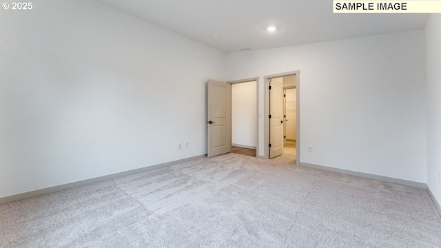 unfurnished room featuring recessed lighting, baseboards, vaulted ceiling, and light colored carpet