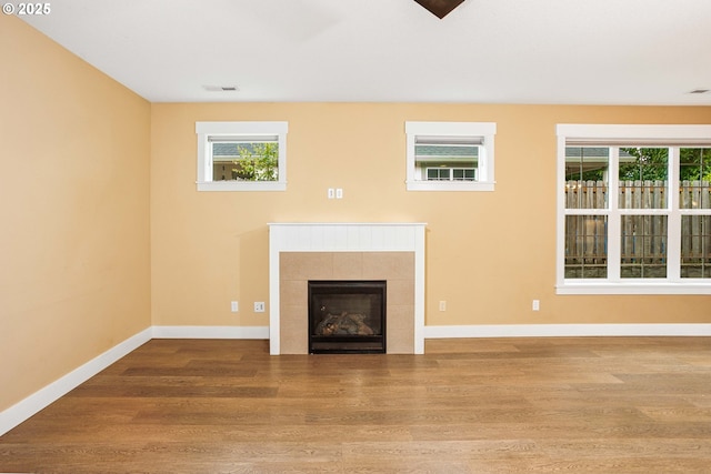 2220 NE Brendan Cir, Vancouver, WA 98663 - unfurnished living room with wood finished floors, plenty of natural light, and a tile fireplace