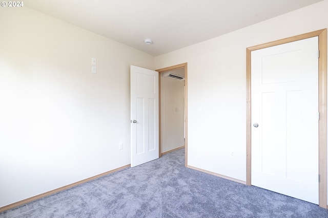 6050 SE 136th Ave, Portland, OR 97236 - unfurnished bedroom featuring baseboards, a wall mounted AC, and carpet flooring