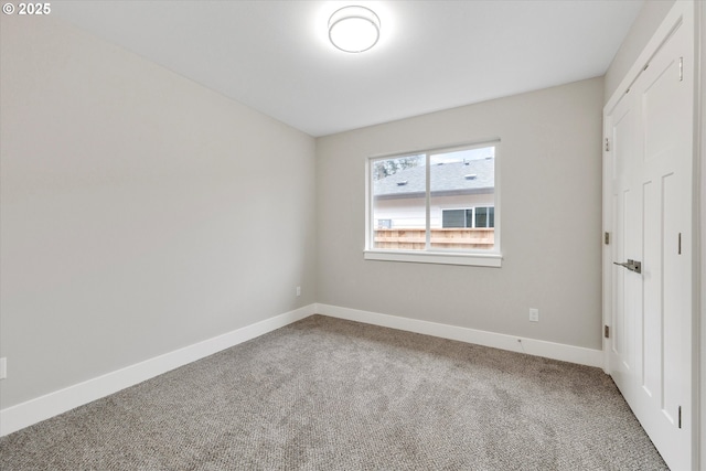 unfurnished bedroom with baseboards and carpet flooring