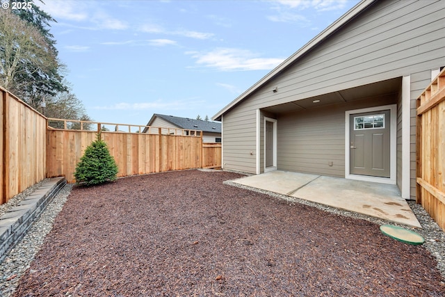 view of yard featuring a patio area and a fenced backyard