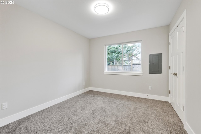 unfurnished bedroom with carpet flooring, electric panel, and baseboards