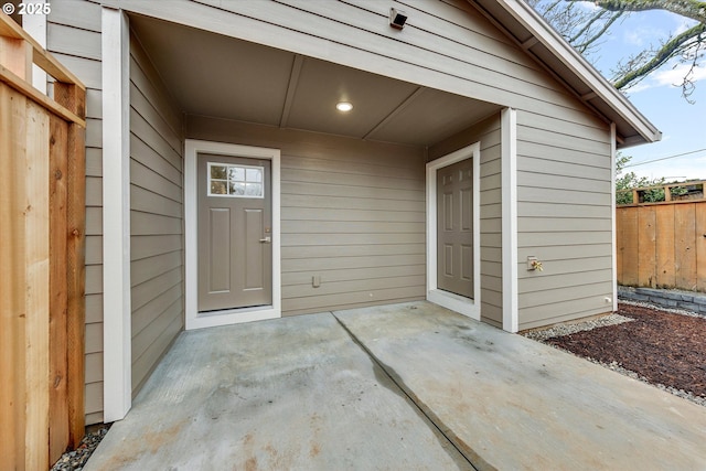 entrance to property with fence and a patio