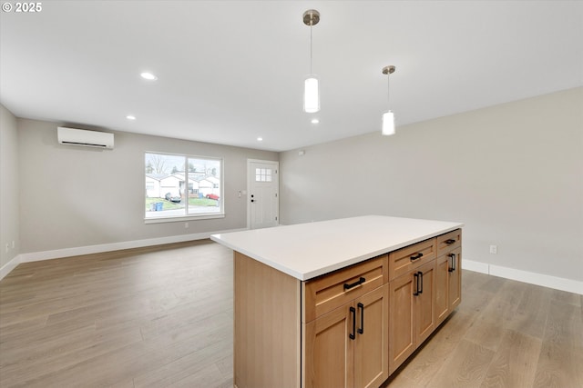 kitchen featuring light wood-style flooring, decorative light fixtures, light countertops, light brown cabinetry, and a wall mounted AC