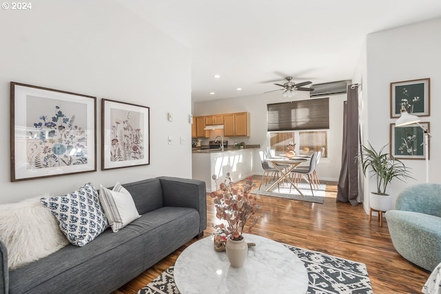 living room with dark hardwood / wood-style floors, sink, and ceiling fan