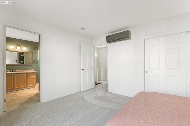 unfurnished bedroom featuring connected bathroom, sink, a wall mounted AC, light carpet, and a closet