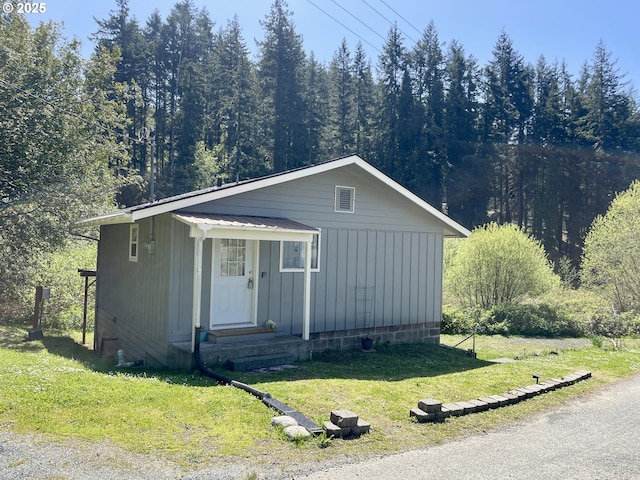 54825 Robinson Rd, Coquille, OR 97423 - bungalow with a front lawn, a view of trees, and board and batten siding