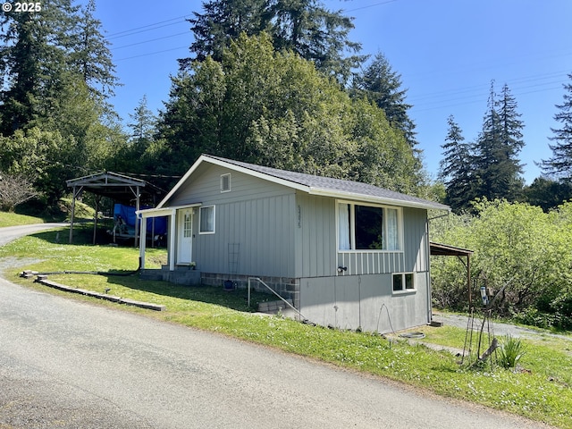 54825 Robinson Rd, Coquille, OR 97423 - view of side of property with entry steps, board and batten siding, and a yard