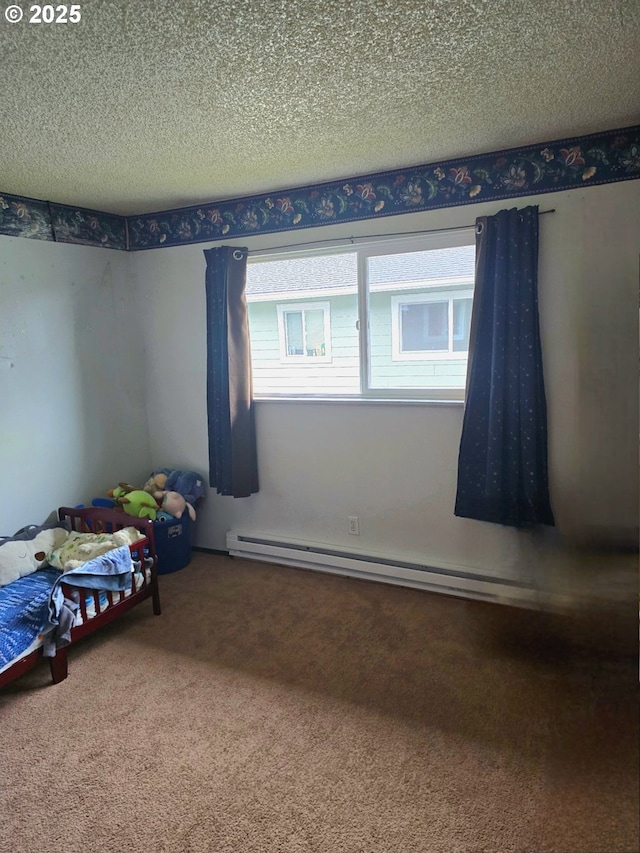 unfurnished bedroom with carpet flooring, a textured ceiling, and baseboard heating