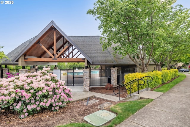 view of home's community with a gazebo, fence, and a swimming pool