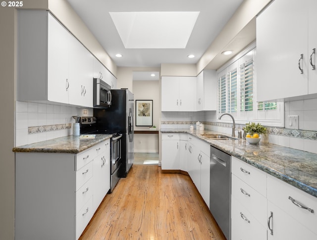 13920 Shireva Dr, Lake Oswego, OR 97034 - kitchen featuring stainless steel appliances, white cabinets, light wood-style flooring, backsplash, and recessed lighting