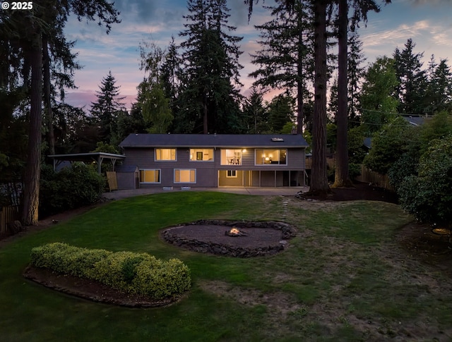 13920 Shireva Dr, Lake Oswego, OR 97034 - back of property at dusk with an outdoor fire pit and a patio