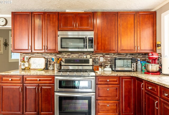 kitchen featuring appliances with stainless steel finishes, dark brown cabinets, decorative backsplash, a textured ceiling, and light stone countertops