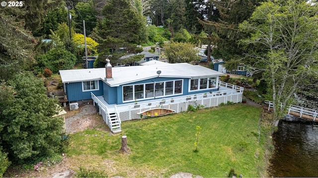 aerial view of property and surrounding area featuring a large body of water