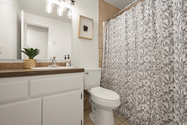 bathroom with a shower with curtain, vanity, toilet, and tile patterned flooring