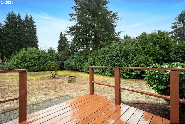 wooden deck featuring an outdoor fire pit