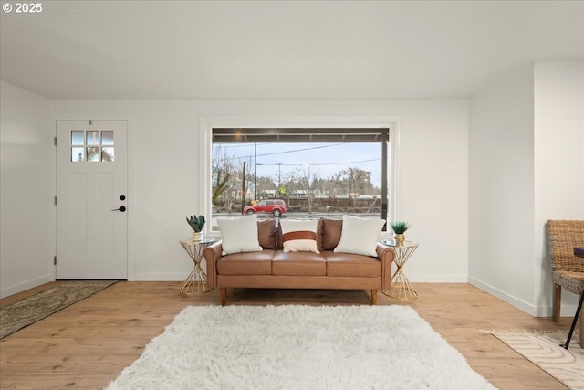 living room with plenty of natural light and light hardwood / wood-style flooring