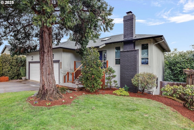 single story home featuring aphalt driveway, a chimney, a shingled roof, a garage, and a front lawn