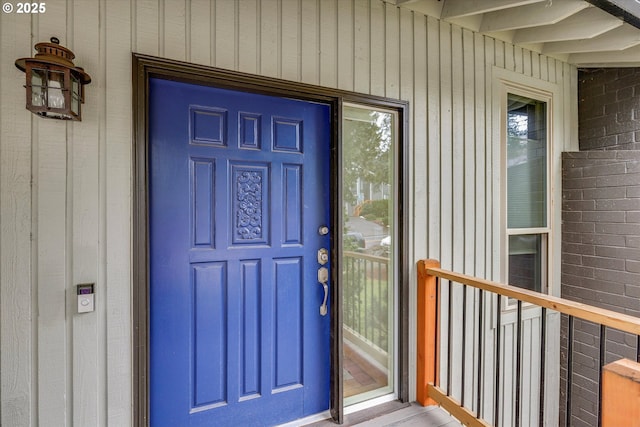 doorway to property featuring brick siding