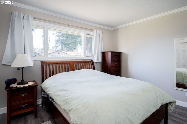 bedroom featuring ornamental molding, dark wood-type flooring, and baseboards