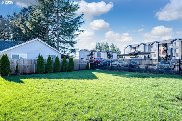 view of yard with fence and a residential view