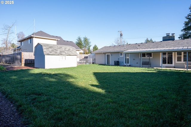 view of yard with central AC and a storage shed