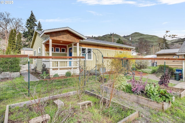 419 State St, Lyle, WA 98635 - view of front of home featuring fence, a vegetable garden, and a mountain view
