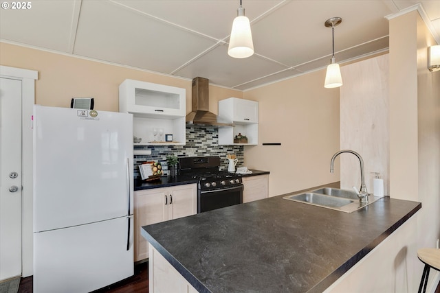 419 State St, Lyle, WA 98635 - kitchen with wall chimney range hood, gas range, a sink, dark countertops, and freestanding refrigerator