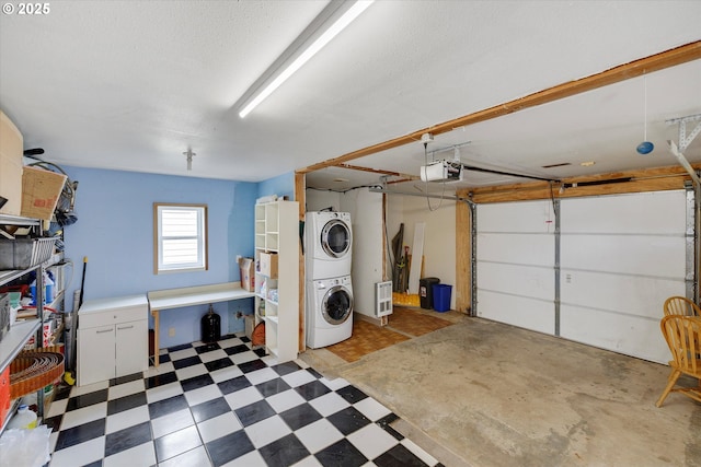 419 State St, Lyle, WA 98635 - garage featuring heating unit, a garage door opener, and stacked washer and clothes dryer