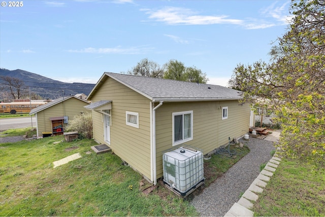 419 State St, Lyle, WA 98635 - view of property exterior featuring roof with shingles, a mountain view, and a yard