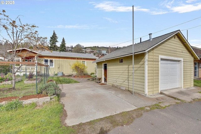 419 State St, Lyle, WA 98635 - garage with a vegetable garden and central AC unit