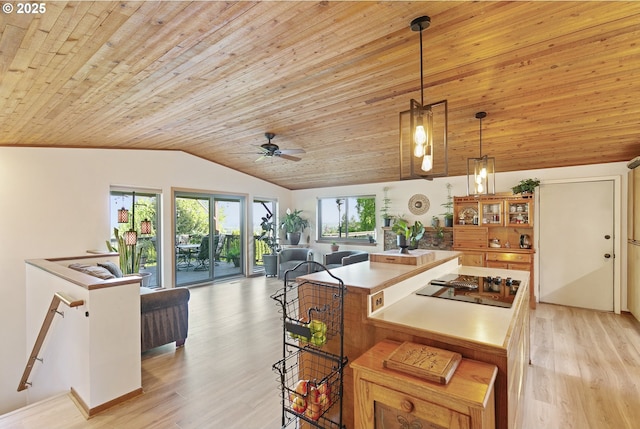 kitchen featuring a ceiling fan, vaulted ceiling, wooden ceiling, and light wood finished floors