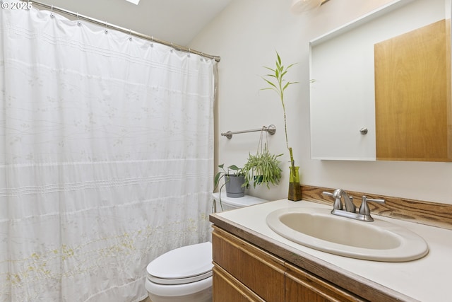 bathroom featuring toilet, a shower with curtain, and vanity