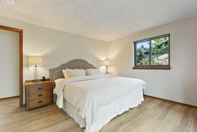 225 NW Brier Ave, Dundee, OR 97115 - bedroom with access to outside, multiple windows, light wood-style floors, a textured ceiling, and baseboards