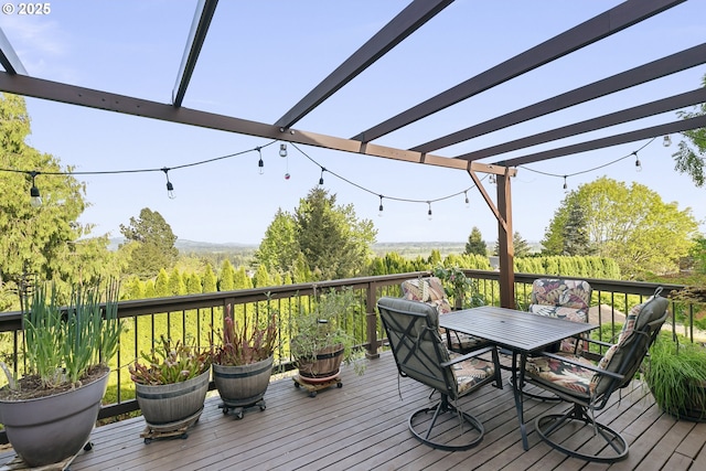 wooden deck with a pergola and outdoor dining space