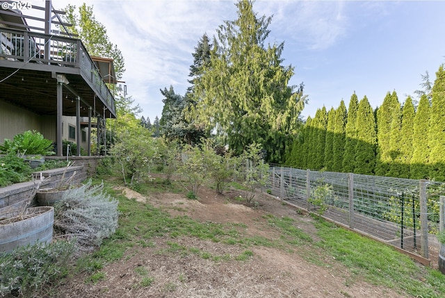 view of yard featuring fence and a wooden deck