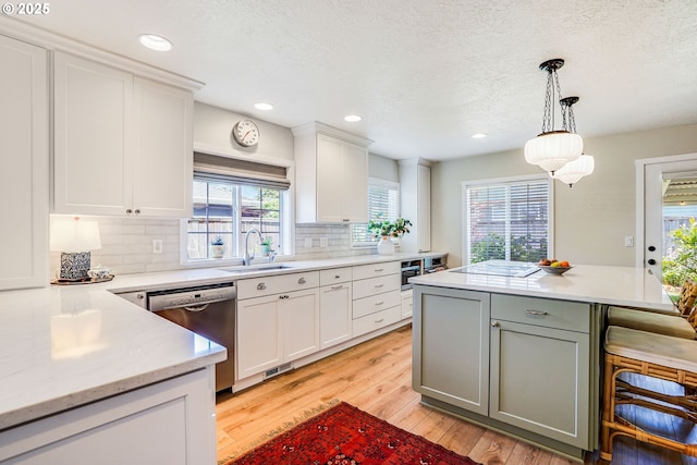 603 Lone Oaks Loop, Silverton, OR 97381 - kitchen featuring dishwasher, light wood-type flooring, white cabinets, recessed lighting, and a textured ceiling