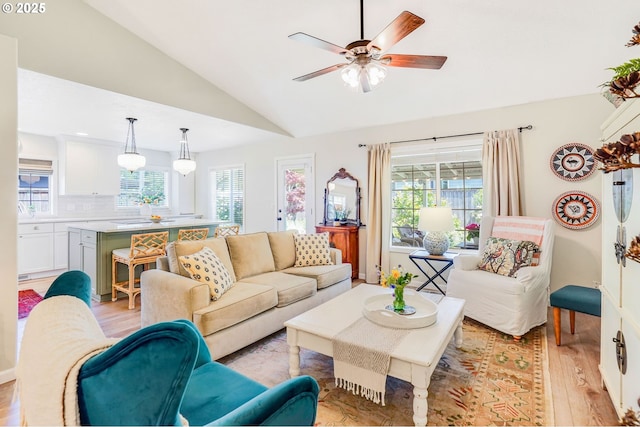 603 Lone Oaks Loop, Silverton, OR 97381 - living area with light wood-type flooring, vaulted ceiling, healthy amount of natural light, and a ceiling fan