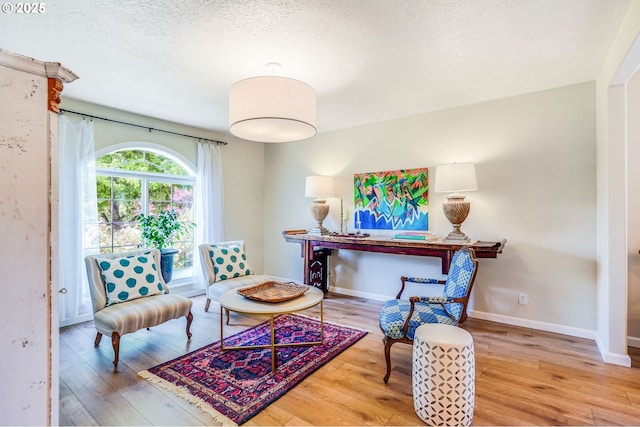 603 Lone Oaks Loop, Silverton, OR 97381 - living area featuring wood finished floors and a textured ceiling