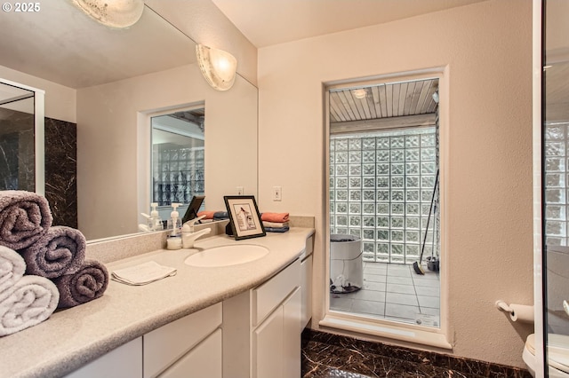 8408 NW Pinnacle Ct, Portland, OR 97229 - full bath with marble look tiles, vanity, toilet, and a shower