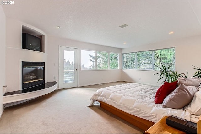 8408 NW Pinnacle Ct, Portland, OR 97229 - carpeted bedroom featuring access to exterior, a glass covered fireplace, recessed lighting, and baseboards