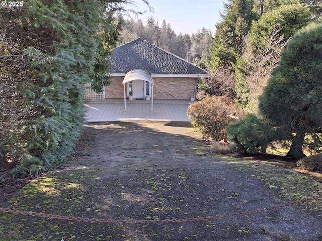 8408 NW Pinnacle Ct, Portland, OR 97229 - view of home's exterior with roof with shingles and driveway