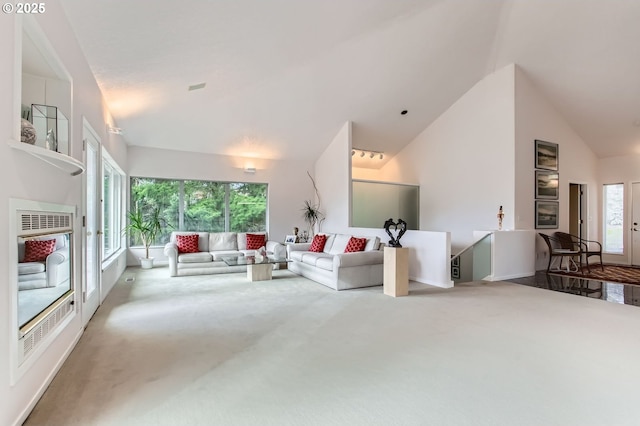 living room featuring high vaulted ceiling and carpet flooring