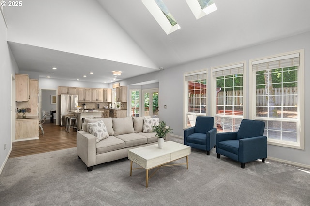 6783 Apollo Rd, West Linn, OR 97068 - carpeted living area with a skylight, baseboards, recessed lighting, high vaulted ceiling, and wood finished floors