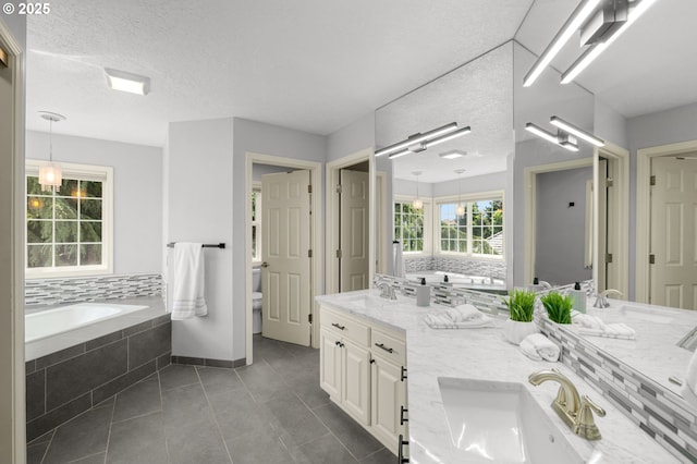 6783 Apollo Rd, West Linn, OR 97068 - bathroom with double vanity, tile patterned flooring, a bath, toilet, and a textured ceiling