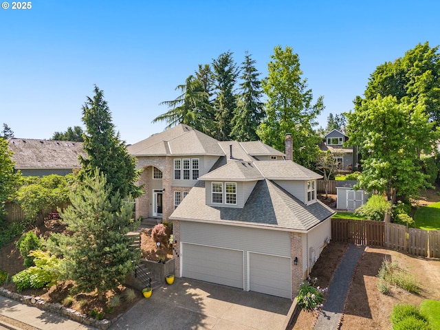 6783 Apollo Rd, West Linn, OR 97068 - view of front facade featuring a shingled roof, brick siding, concrete driveway, a chimney, and a garage