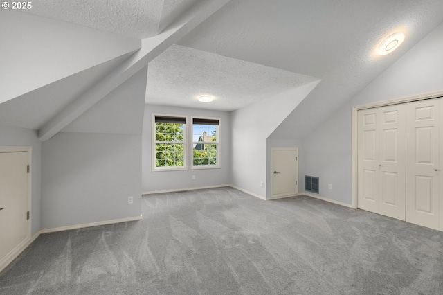 6783 Apollo Rd, West Linn, OR 97068 - bonus room with a textured ceiling, lofted ceiling, carpet floors, and baseboards