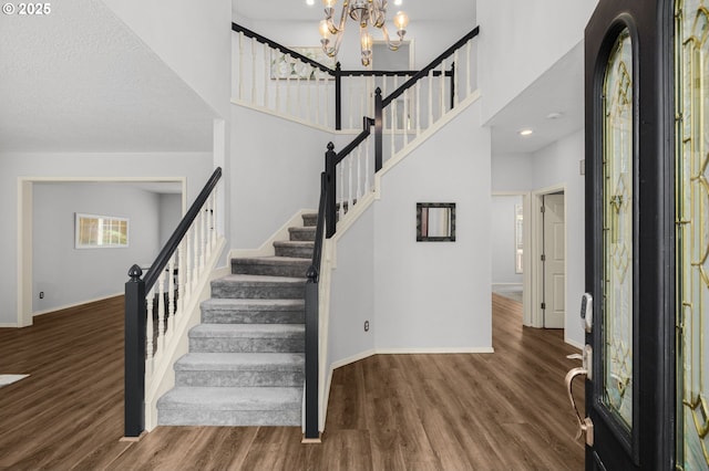 6783 Apollo Rd, West Linn, OR 97068 - foyer featuring stairway, baseboards, wood finished floors, and a towering ceiling